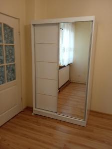 a large mirror in a room with a door at Apartament CURIE - studio in Międzyzdroje
