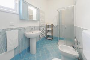 łazienka z umywalką, toaletą i lustrem w obiekcie Casa Vacanze Penelope w mieście Alessano +9 zdjęć