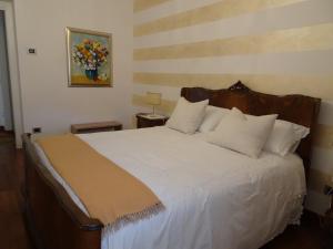 a bedroom with a large white bed with white pillows at CasaRò in Albano SantʼAlessandro