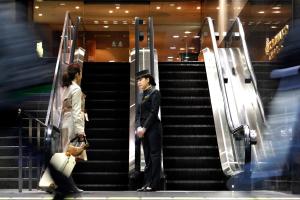 a man standing on the stairs in a building at Hotel Granvia Kyoto in Kyoto