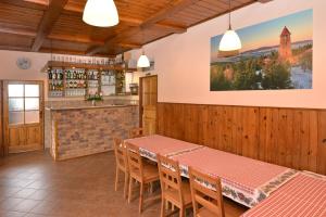 a restaurant with a table and chairs and a bar at Holiday Home Jizerka in Nova Ves nad Nisou