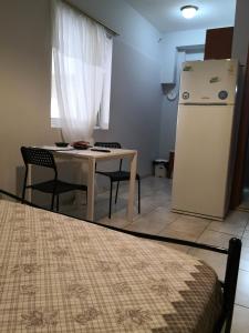 a small kitchen with a table and a refrigerator at House in the center of Piraeus next to the port and the metro!! in Piraeus