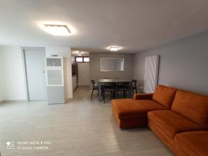 a living room with a couch and a table at Appartamento Le Ancore in Marciana Marina