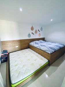 a bed in a room with avertisementatronatronatronstrationstrationstration at Aqua Blue Lakeview Apartment Ohrid in Peštani