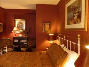 1 dormitorio con 1 cama y 1 silla en Auberge King Edward Bed and Breakfast, en Ottawa