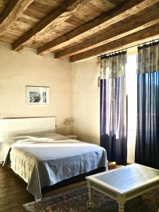 a bedroom with a bed and a large window at "La Maison de Villars" au coeur de la nature in Pressac