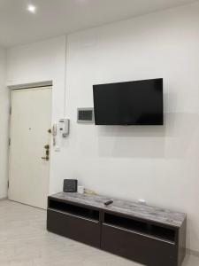 a flat screen tv hanging on a white wall at Il filo di Jordi in Savona