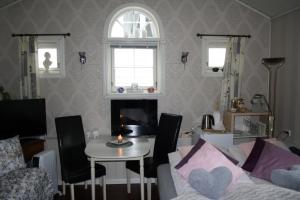 a living room with a couch and a table with a candle at Huset på hauen in Volda