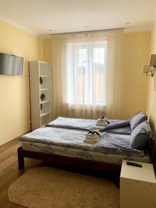 a bed in a room with a window at Homey apartment on Vicheva Str. in Lviv