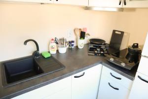 a kitchen counter with a sink and a stove at Maria Apartment Rootsi 9 in Kuressaare +1 photo