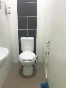 a bathroom with a white toilet and a sink at iG Hotel in Alor Setar