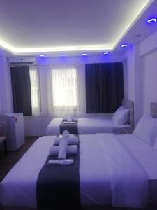 a hotel room with two beds with purple lighting at Galataport suites in Istanbul