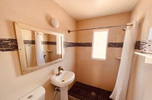 a bathroom with a sink and a toilet and a mirror at Siesta Inn Sarasota - Indian Beach in Sarasota +11 photos