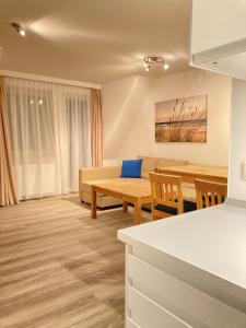 a living room with a couch and a table at Apartmenthaus Jasmin in Büsum