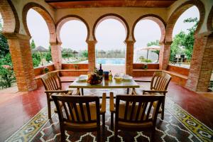 an outdoor dining room with a table and chairs at Casa Rural San Antonio in Cabra