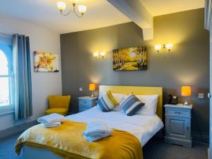 
a bedroom with a bed and a nightstand at The Swan Hotel in Wadebridge
