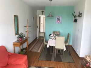 a living room with a table and a chair at Apto Praia Atalaia in Aracaju