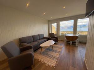 a living room with a couch and a table at Botnen Camping in Botnen