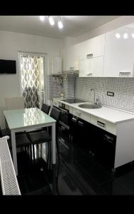 a kitchen with a sink and a counter top at Apartament Nicolas in Brezoi