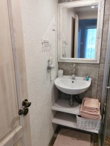 a bathroom with a sink and a mirror at Holiday Home Kolka in Kolka