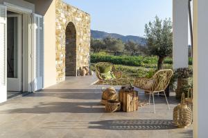 a patio with chairs and tables on a house at BORGO DEL FRANCO in Castellabate