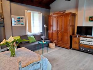 a living room with a couch and a tv at Errekaondo in Areatza