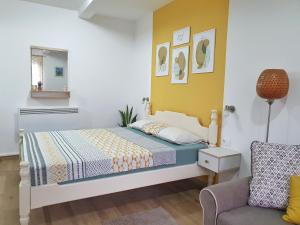 a bedroom with a bed and a chair at Apartments Gruda in Cetinje