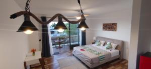 a bedroom with a bed and two hanging lights at Labrize Studio in La Gaulette