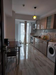 a kitchen with a table and a dining room at BYA Luxury in Valea Lupului
