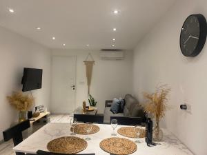 a living room with a table with wine glasses on it at Luxury Lavender in Larnaca