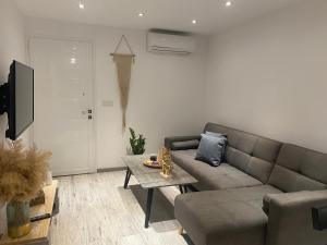 a living room with a couch and a table at Luxury Lavender in Larnaca