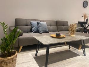 a living room with a couch and a coffee table at Luxury Lavender in Larnaca
