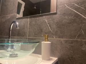 a bathroom sink with a faucet and a mirror at Luxury Lavender in Larnaca