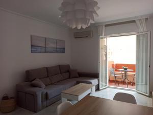 a living room with a couch and a table at Apartamento la Noria 2 Playa in San Luis de Sabinillas