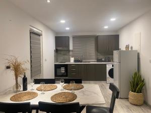 a kitchen with a table and chairs and a refrigerator at Luxury Lavender in Larnaka