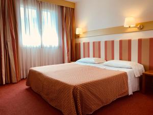 Posteľ alebo postele v izbe v ubytovaní Eurohotel Palace Maniago
