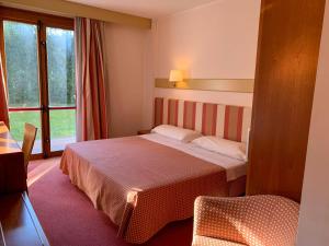 Posteľ alebo postele v izbe v ubytovaní Eurohotel Palace Maniago