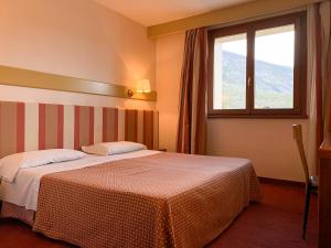 Posteľ alebo postele v izbe v ubytovaní Eurohotel Palace Maniago