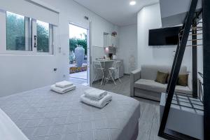 a bedroom with a bed and a living room with a couch at Comfort Stay Athens Airport Hotel - FREE shuttle from and to the airport in Spáta