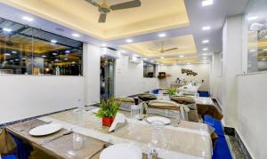 a dining room with a long table and chairs at Hotel Bandhan Residency in Kolkata