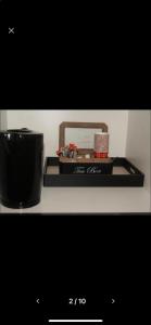 ein schwarzes Tablett mit einer Kerze und einem Behälter auf einem Regal in der Unterkunft Appartement Studio Tournai in Tournai