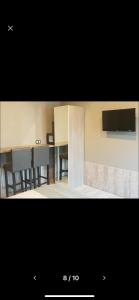 a picture of a kitchen with some tables and chairs at Appartement Studio Tournai in Tournai