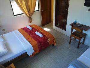Postel nebo postele na pokoji v ubytování Hostal La Casa de Luis