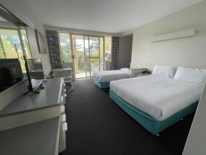 Postel nebo postele na pokoji v ubytování Parklane Motel