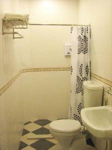 a bathroom with a toilet and a sink at SR Inn in Simpang Renggam