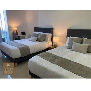 two beds sitting next to each other in a bedroom at Reserva del Mar 810 in Gaira +29 photos