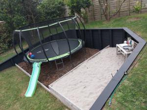 a trampoline with a surfboard on top of it at Guest house on Plummers Point in Tauranga