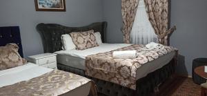 a small bedroom with two beds and a window at La Mer Boutique Hotel & Guesthouse in Istanbul