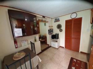 a small kitchen with a table and a refrigerator at Westskye in Saint James