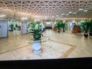 a large lobby with a table with flowers on it at Harbor Towers Yacht and Racquet Club on Siesta Key in Sarasota